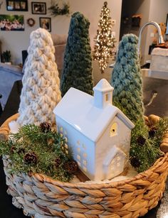 a white house sitting in a basket on top of a table