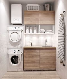 a washer, dryer and cabinets in a small room with tile flooring