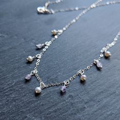 "\"Oprah\" ♀️ Sterling silver chain necklace with pearls and amethyst beads ♀️ Amethyst keywords: Sobriety and Psychic ♀️ Pearl keywords: Innocence and Generosity ♀️ Nickel free ♀️ Model is wearing 16 in. necklace \"Think like a queen. A queen is not afraid to fail. Failure is another steppingstone to greatness.\" Oprah Winfrey" Delicate Silver Jewelry With Dangling Beads, Silver Amethyst Necklace For Wedding, Wedding Amethyst Birthstone Necklace, Amethyst Birthstone Necklace For Wedding, Teardrop Pendant Necklace With Dangling Beads For Gift, Wedding Silver Charm Necklaces With Pearl Drop, Silver Pearl Necklace With Dangling Beads For Gifts, Silver Crystal Necklace With Dangling Beads As Gift, Silver Crystal Necklaces With Dangling Beads As Gift