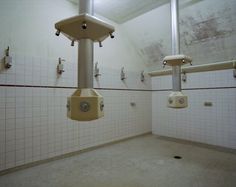 a public restroom with urinals and tiled walls