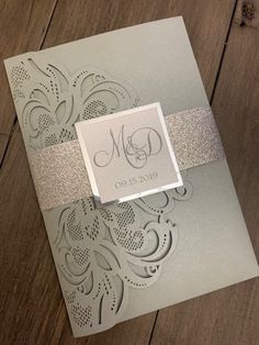 a wedding card with a silver ribbon on it