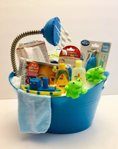 a blue bucket filled with baby items on top of a table