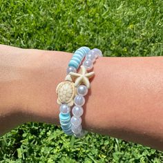 Here's my beachy blue turtle bracelet set! It comes with a blue + white bracelet with a turtle & a pearl + starfish bracelet! Hope you guys like it!! (Colors may be a bit different in real life) Casual Beaded Bracelets With Starfish Charm For The Beach, Casual Adjustable Starfish Beaded Bracelets, Casual Blue Beaded Bracelets With Starfish Charm, Casual Blue Jewelry With Starfish Charm, Casual Bracelets With Starfish Charm For Vacation, Casual Starfish Bracelets As Gift, Casual Starfish Bracelet As Gift, Casual Starfish Bracelet For Gift, Adjustable Casual Bracelets With Starfish Charm