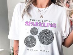 This Night is Sparkling Shirt | Concert TShirt | Speak Now T-Shirt | Album Tee | Eras Fan Merch Gift  This Night is Sparkling shirt is the perfect thing to wear to your favorite concert. It also makes a great gift for the music lover in your life. Wear this Speak Now inspired T-shirt to the Era's Tour and have an Enchanted night! * Bella and Canvas Brand Shirts * Unisex Adult Size * Shirts are styled with rolled sleeves in the photos for mockup purposes only * Photo props are not included Print Crew Neck T-shirt With Letter Print For Night Out, Disco Style Graphic Print T-shirt With Short Sleeves, Letter Print Crew Neck T-shirt For Night Out, Speak Now Shirt, Eras Tour Speak Now, Enchanted Night, Speak Now, Concert Tshirts, Concert Tees