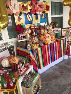 a table filled with lots of food and balloons