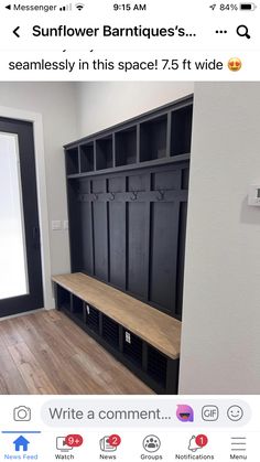 an empty room with a bench and coat rack