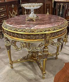 an ornately decorated table with a marble top