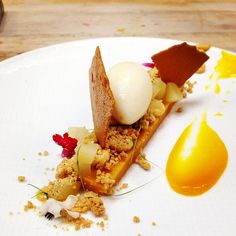 a white plate topped with food on top of a wooden table