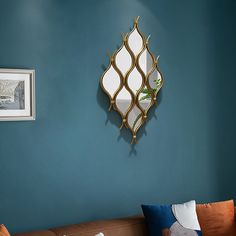 a living room with a brown couch and blue walls, including a mirror on the wall