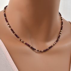 "Garnet Bead Necklace with 14K Gold Filled. January Birthstone Necklace. Length: 16\" - 18\" Adjustable The deep, wine red of this genuine garnet necklace is pure luxury. The faceted surfaces create a subtle, elegant sparkle. 14Kt gold filled beads and clasp give a timeless finish. This necklace is easy to dress up or down, and makes a great gift. What is Gold Filled? Gold filled jewelry has a layer of solid gold that is 100 times thicker than that of gold plated jewelry. It is hypoallergenic, resistant to tarnish, and will not chip or fade over time. Gold filled has an appearance nearly identical to solid gold, but with a more affordable price. It is highly durable and with proper care will last a lifetime. Browse my shop: ALLDANAE.etsy.com" Luxury Garnet Birthstone Necklace, Garnet Bead Necklace, Red Garnet Necklace, January Birthstone Necklace, Garnet Necklace, Garnet Jewelry, January Birthstone, Birthstone Necklace, Gold Filled Jewelry