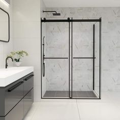 a bathroom with a sink, mirror and shower stall in white marbled tile on the wall