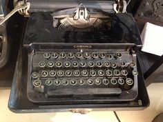 an old fashioned typewriter sitting on top of a table