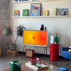 a living room filled with furniture and a flat screen tv on top of a wooden stand