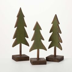 three wooden christmas trees are on display