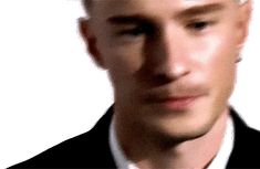 a blurry image of a man in a suit and tie looking at the camera