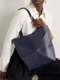 Bags have had a functional update this season - it's all about styles that can be converted so you can get maximum mileage. Loewe's medium 'Puzzle' tote has an origami-like construction that can be folded down when you're storing it or traveling. The leather is smooth and slouchy and the suede lining exquisitely soft. Chic Blue Calf Leather Bag, Loewe Puzzle, Large Leather Tote Bag, Perfume Design, Large Leather Tote, Classic Bags, Green Beige, Home Lifestyle, Orange Bag