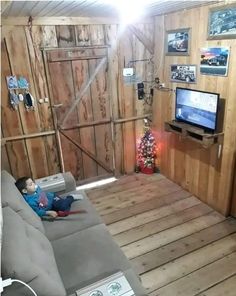 a living room filled with furniture and a flat screen tv on top of a wooden floor