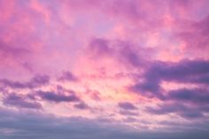 the sky is pink and purple with clouds