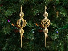 two wooden ornaments hanging from a christmas tree