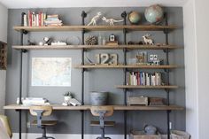 a living room filled with lots of shelves covered in books and knick knacks