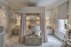 a bedroom with a canopy bed and chandelier hanging from it's ceiling