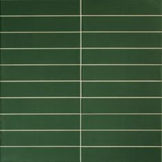 a green tile wall with horizontal lines on it