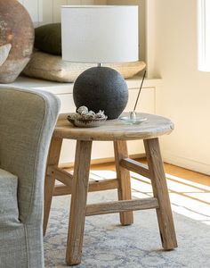 a table with a lamp on top of it next to a couch