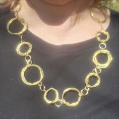 Haphazard circles of gold brass wire make up this unique easy to wear chain necklace. Chain necklace is entirely handcrafted of wrapped brass wire into different size circles. Lightweight necklace makes a great layering necklace. Each necklace is individually made and may vary slightly from what is pictured. Have FUN. BE original. WEAR CKS jewelry. Metal Chain Necklace For Jewelry Making, Metal Round Chain Necklace For Jewelry Making, Adjustable Metal Chain Necklace, Gold Chain Link Jewelry With Metal Ring, Round Brass Chain Jewelry, Elegant Round Necklaces With Metal Ring, Metal Circle Chain Necklace For Gift, Brass Chain Necklace With Lobster Clasp, Round Long Chain Necklace For Gift