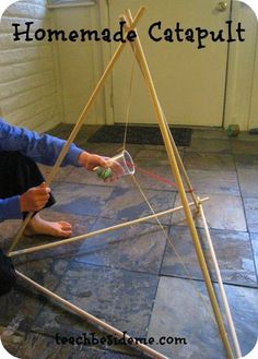 someone is making a homemade catapult out of sticks