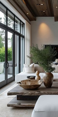 a living room filled with furniture and a large glass door leading to the outside patio