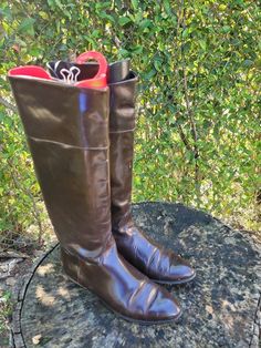 "Vintage Joan and David tall equestrian style brown leather riding boots. Classic and elegant equestrian flat boots for fall and winter! Perfect for long dresses! Size 9.5 Pull on style with pull tabs. *BOOTS HAVE WEAR AND TEAR ON THE INSIDE AND OUTSIDE OF BOTH BOOTS * Length: 10\" Width: 3 1/2\" Heel: 1\" Height: 14\" Top: 14\" Color: Brown Condition: Good Vintage Brand: Joan and David" Classic Brown Knee-high Boots For Riding, Classic Brown Knee-high Riding Boots, Brown Wide Calf Knee-high Boots For Riding, Brown Winter Riding Knee-high Boots, Brown Riding Boots For Winter, Winter Riding Boots In Brown, Brown Wide Calf Boots For Riding, Brown Knee-high Riding Boots With Round Toe, Classic Brown Knee-high Boots With Almond Toe