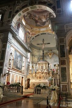 the inside of a church with paintings on the walls