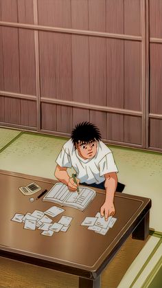 an anime boy sitting at a table with papers and pens in front of his face