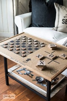 a coffee table made out of cork with buttons and magnets on it in front of a couch