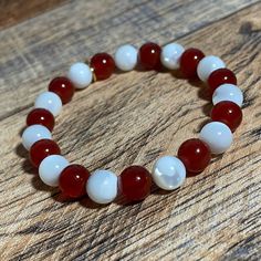 ✨❤️🤍✨Merry and Bright✨❤️🤍✨ MADE WITH 2 NATURAL GEMSTONES + CANDY CANE DAINTY CHARM: ❤️Red Agate * Self-Confidence, Balance, Harmony 🤍Mother of Pearl * Imagination, Protection, Intuition 💛 Gold-Filled OR Sterling Silver-Filled Candy Cane Dainty Charm *Adult Small and Child Size Shown. Child Size will fit wrists that measure 4-5 inches. BRACELET INTENTION * This 'Merry and Bright' bracelet will allow you to shine your bright light throughout the holidays by exploring your imagination, trusting Affordable Beaded Holiday Bracelets, Cheap Red Holiday Bracelets, Red Carnelian Bracelets For Gifts, Red Carnelian Bracelets As Gift, Red Carnelian Bracelets As A Gift, Elegant White Bracelets For Holiday, White Spiritual Bracelet For Valentine's Day, Valentine's Day White Pearl Bracelet With Round Beads, Red Spiritual Bracelets For Wedding