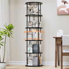 a book shelf in the corner of a room next to a table with a potted plant on it