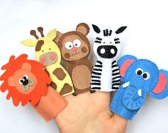 a hand that has some kind of animal puppets on it's palm and is holding several different types of stuffed animals