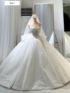 a white wedding dress on display in front of a mirror