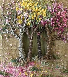 a painting of three trees with colorful flowers