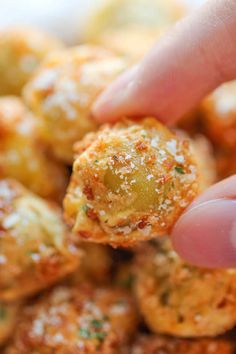 a person is holding up some food to take it out of the oven with their hand