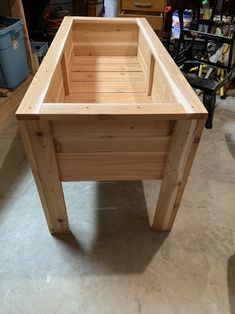 a wooden box sitting on top of a table in a room filled with other items