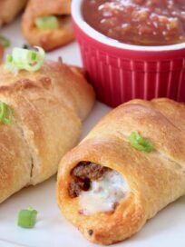 some taco croissants are sitting on a plate