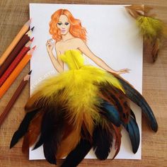 a drawing of a woman in a yellow dress surrounded by feathers and colored pencils