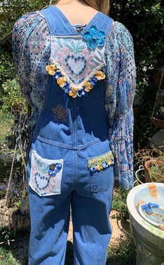 These adorable overalls are truly vintage, I remember the Bum brand in the 1970's as being one of the cool brands to have. These are a size small, but because overalls are designed to fit loosely and can be adjusted in a variety of ways (straps, buttons on the side, etc.) I would estimate these could fit a tall size 4 up to a size 10 in women's sizes. The pocket of the bib I added vintage embroidered linen of flowers and leaves. At the top of the bib, there was a logo that I didn't like so I put Retro Cotton Denim Jumpsuit With Bib Front, Retro Bib Front Denim Jumpsuit, Retro Spring Overalls With Bib Front, Vintage Blue Cotton Overalls, Vintage Blue Cotton Shortalls, Blue Vintage Cotton Shortalls, Vintage Cotton Shortalls For Spring, Cotton Overalls For Festivals, Cotton Overall Jumpsuits And Rompers For Festival