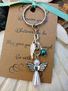 a keychain with an angel charm attached to it