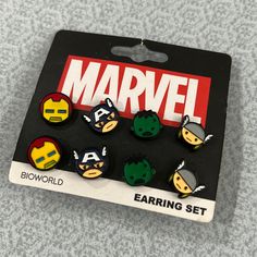 a set of six avengers buttons sitting on top of a table