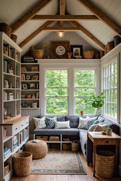 a living room filled with lots of furniture and bookshelves next to a window