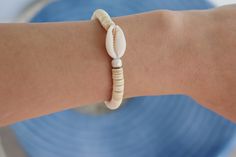 cowrie shell beaded bracelet made with elastic stretchy cord, its a great bracelet to wear for the beach. Casual Cowrie Shell Bracelets For Vacation, Casual Cowrie Shell Bracelets, Cowrie Shell Beaded Bracelets For Vacation, Beachy Cowrie Shell Strand Bracelets, Casual Cowrie Shell Bracelets For Beach, Cowrie Shell Beaded Bracelets For The Beach, White Cowrie Shell Bracelets For Beach, White Cowrie Shell Beaded Bracelet For Beach, Casual Cowrie Shell Bracelets For Summer