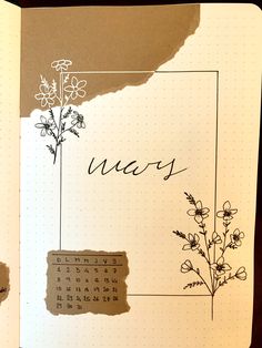 an open notebook with flowers and writing on it