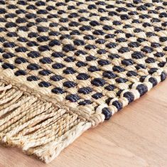 a close up of a rug on a wooden floor